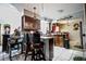 Open-concept kitchen featuring tiled floors, a breakfast bar, dark wood cabinets, and ample counter space at 11411 N 19Th St, Tampa, FL 33612