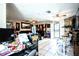 Bright living room with tile flooring, ceiling fans, a stone fireplace, and multiple entryways at 11411 N 19Th St, Tampa, FL 33612