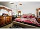 Main bedroom with a ceiling fan and an ornate dresser with mirror at 11411 N 19Th St, Tampa, FL 33612