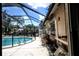 Enclosed pool area with views of the pool, surrounding patio, and some exterior structure at 11411 N 19Th St, Tampa, FL 33612