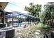 View of the screened in pool and patio. The patio is perfect for entertaining and relaxing at 11411 N 19Th St, Tampa, FL 33612