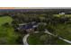 Aerial view of the property showcasing the home, surrounding trees, and a long driveway at 11441 Hammock Oaks Ct, Lithia, FL 33547