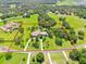 Expansive estate featuring a custom home, pool, and sprawling acreage surrounded by lush greenery at 11441 Hammock Oaks Ct, Lithia, FL 33547