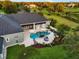 Aerial view of backyard featuring a pool, patio, lounge chairs, and mature trees at 11441 Hammock Oaks Ct, Lithia, FL 33547