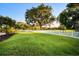 Expansive backyard with a white fence, green grass, and mature trees at 11441 Hammock Oaks Ct, Lithia, FL 33547