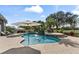 Backyard swimming pool with surrounding brick-paved patio, mature landscaping, and lounge chairs at 11441 Hammock Oaks Ct, Lithia, FL 33547