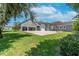 Wide backyard featuring expansive concrete parking area and lush green grass at 11441 Hammock Oaks Ct, Lithia, FL 33547