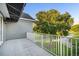 Outdoor balcony offers a relaxing view of lush landscaping and a shaded backyard at 11441 Hammock Oaks Ct, Lithia, FL 33547