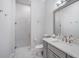 Well-lit bathroom featuring a glass shower, gray vanity, and contemporary fixtures at 11441 Hammock Oaks Ct, Lithia, FL 33547