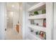 Bright bathroom featuring walk-in shower, floating shelves, and modern neutral decor at 11441 Hammock Oaks Ct, Lithia, FL 33547