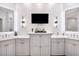 Bright bathroom with dual sinks, quartz countertop vanity, and decorative wall sconces at 11441 Hammock Oaks Ct, Lithia, FL 33547