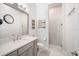 Stylish bathroom with a glass-enclosed shower, gray vanity, and decorative wall art at 11441 Hammock Oaks Ct, Lithia, FL 33547