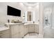 Bright bathroom boasts detailed wallpaper, television, illuminated mirror, and plentiful storage at 11441 Hammock Oaks Ct, Lithia, FL 33547
