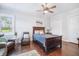Inviting bedroom featuring dark wood furniture, a plush recliner, and ample natural light at 11441 Hammock Oaks Ct, Lithia, FL 33547