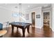 Entertaining game room with pool table, hardwood floors, and stylish lighting fixtures at 11441 Hammock Oaks Ct, Lithia, FL 33547