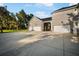 Spacious four-car garage with ample parking space and a covered breezeway to the main house at 11441 Hammock Oaks Ct, Lithia, FL 33547