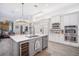 Open kitchen boasts a large island with bar seating and high-end stainless steel appliances at 11441 Hammock Oaks Ct, Lithia, FL 33547