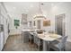 Bright kitchen with stainless appliances, tiled backsplash, large island, and eat in dining area at 11441 Hammock Oaks Ct, Lithia, FL 33547