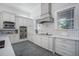 Well-appointed kitchen with white cabinetry, stone countertops, and modern stainless steel appliances at 11441 Hammock Oaks Ct, Lithia, FL 33547