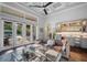 Elegant living room featuring a wet bar, coffered ceilings, and access to the outdoor patio at 11441 Hammock Oaks Ct, Lithia, FL 33547