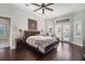 Spacious main bedroom with wood floors, tray ceilings, sitting area, and natural light at 11441 Hammock Oaks Ct, Lithia, FL 33547