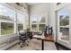 Bright office space with large windows, wood floors, and an ergonomic workspace at 11441 Hammock Oaks Ct, Lithia, FL 33547