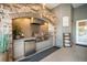 Outdoor kitchen featuring a stone facade, stainless steel appliances, and counter space at 11441 Hammock Oaks Ct, Lithia, FL 33547