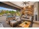 Relaxing outdoor living area with comfortable seating and a summer kitchen, overlooking a stunning pool and landscape at 11441 Hammock Oaks Ct, Lithia, FL 33547