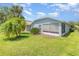 Backyard featuring a well-maintained lawn, bushes, and a screened in patio at 11620 Crest Creek Dr, Riverview, FL 33569