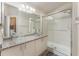 Modern bathroom with dual vessel sinks and glass-enclosed shower at 11620 Crest Creek Dr, Riverview, FL 33569