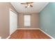 Bedroom with ceiling fan, wood flooring, and a closet at 11620 Crest Creek Dr, Riverview, FL 33569