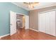 Comfortable bedroom featuring hardwood floors, ceiling fan, and an open doorway view to the kitchen at 11620 Crest Creek Dr, Riverview, FL 33569