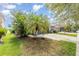 Landscaped front yard showcasing lush greenery and mature trees that adds a touch of nature to the property at 11620 Crest Creek Dr, Riverview, FL 33569