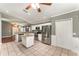 Open kitchen features stainless appliances, granite counters and tile flooring at 11620 Crest Creek Dr, Riverview, FL 33569