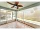 Enclosed patio featuring screened windows, tile floor, and ceiling fan at 11620 Crest Creek Dr, Riverview, FL 33569