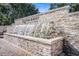 A decorative waterfall feature, framed by stone and brick, adds an elegant touch to the community entrance at 11620 Crest Creek Dr, Riverview, FL 33569
