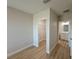 Light and bright bedroom with neutral paint, wood-look flooring, and a walk-in closet at 12231 Kirk Ave, Port Charlotte, FL 33981