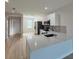 Open concept kitchen with white cabinets and stainless steel appliances, providing a view into the living area at 12231 Kirk Ave, Port Charlotte, FL 33981