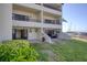 Spacious backyard with a patio, lush lawn, and beautiful views of the adjacent marina at 128 1St Street E. # 102, Tierra Verde, FL 33715