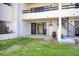 Lovely backyard with a spiral staircase, sliding glass door access, and a well-maintained lawn at 128 1St Street E. # 102, Tierra Verde, FL 33715