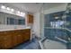 Bathroom features a vanity, toilet, and enclosed glass shower, blending functionality with a stylish design at 128 1St Street E. # 102, Tierra Verde, FL 33715