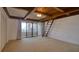 Bedroom with a wood-beamed ceiling, ladder, and sliding glass doors to the balcony at 128 1St Street E. # 102, Tierra Verde, FL 33715