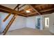 Bedroom boasts wood-beamed ceiling, ladder access and a bathroom with glass shower at 128 1St Street E. # 102, Tierra Verde, FL 33715