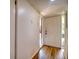 Bright entryway with wood-look floors and a white front door, offering a welcoming entrance to the home at 128 1St Street E. # 102, Tierra Verde, FL 33715