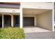 Exterior of unit 102 featuring a private garage and entrance, providing convenience and privacy at 128 1St Street E. # 102, Tierra Verde, FL 33715