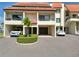 Charming condo with covered parking, a well-manicured garden, and a welcoming entrance at 128 1St Street E. # 102, Tierra Verde, FL 33715