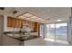 Bright kitchen featuring wood cabinetry, stainless steel appliances, and sliding glass doors at 128 1St Street E. # 102, Tierra Verde, FL 33715