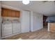 Convenient laundry room featuring a washer, dryer, and upper cabinets at 128 1St Street E. # 102, Tierra Verde, FL 33715