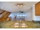 Open-concept living area with a staircase and abundant natural light, creating a bright and inviting space at 128 1St Street E. # 102, Tierra Verde, FL 33715