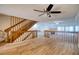 Open living space featuring tile floors, ceiling fans, and a staircase at 128 1St Street E. # 102, Tierra Verde, FL 33715